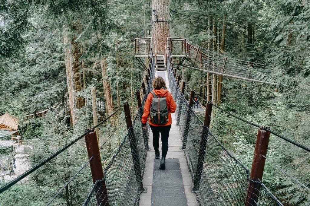 Woman walking over suspension bridge in Vancouver