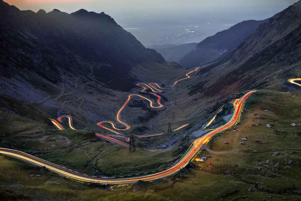 The Transfagarasan curved road seen with car trail lights at the blue hour. Photo taken on 31st of August 2019, Sibiu county, Romania.