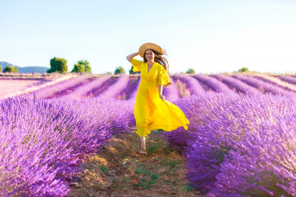 Woman running on a lavender field in Provence, France
