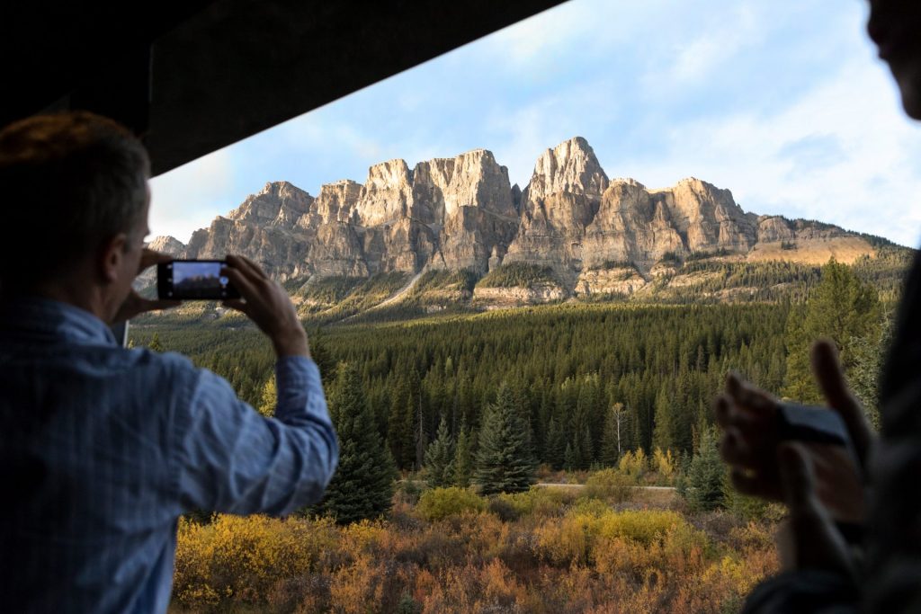 man taking a photo of mountains