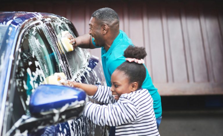 Family follows green driving ti[ and washes car together