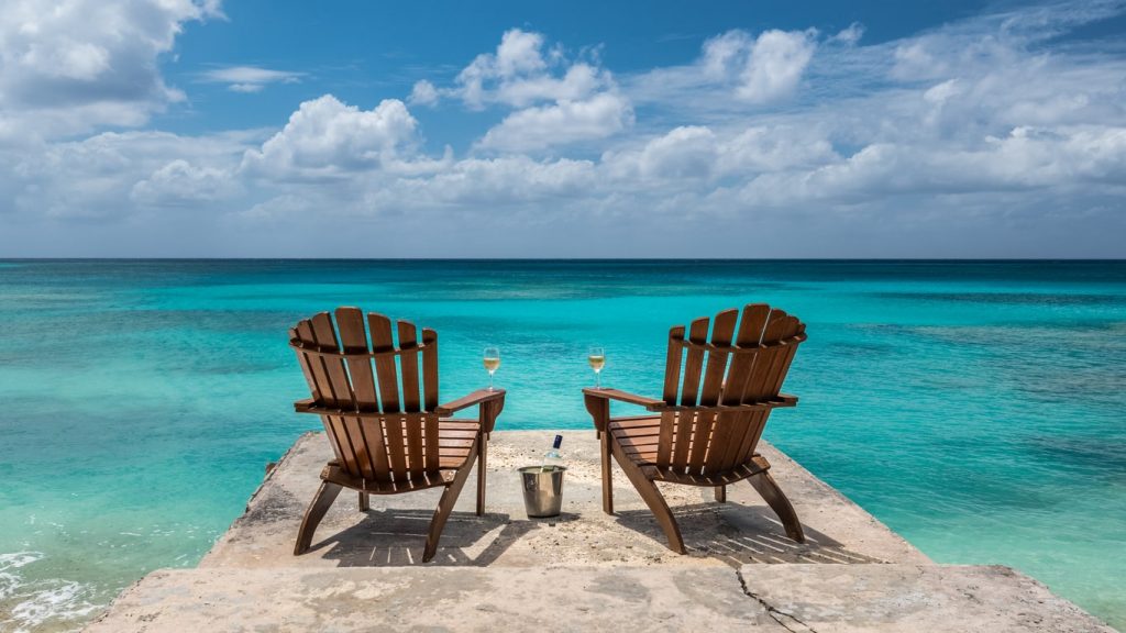 two chairs overlooking blue waters