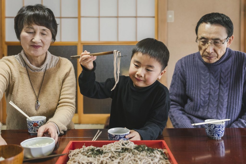 family eating Toshikoshi soba noodles on new years eve in Japan
