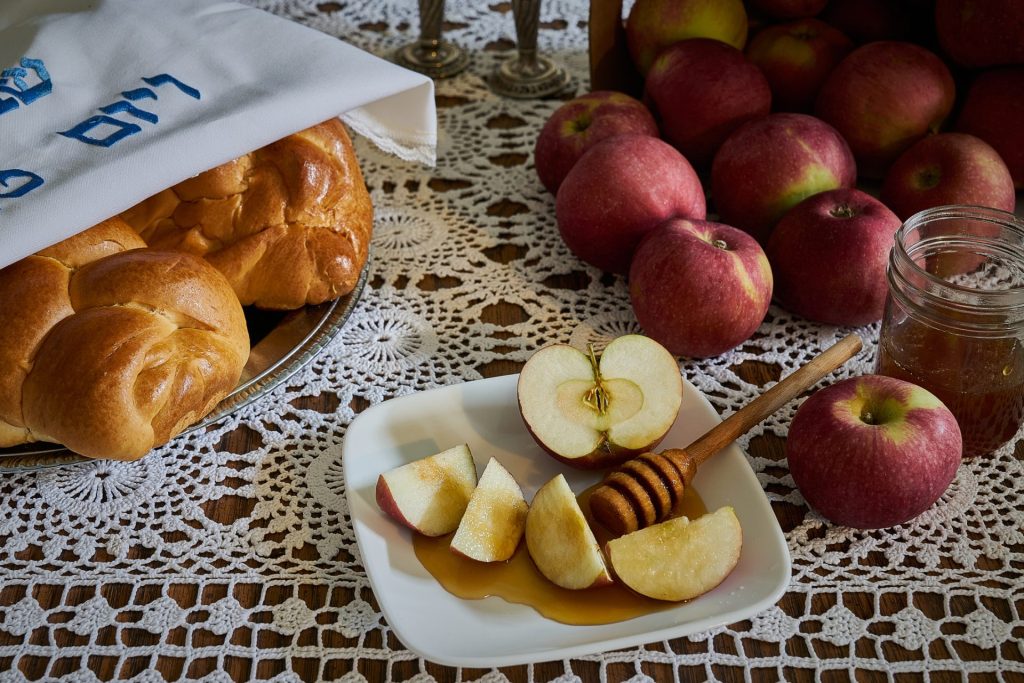 Rosh Hashanah Holiday Table with Apples, Honey and Challah Bread