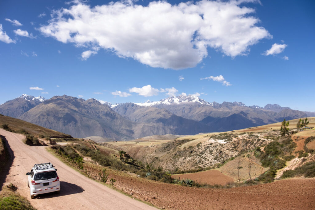 View Of A Car On A Mountain Road In The Andes, Near Moray, Peru