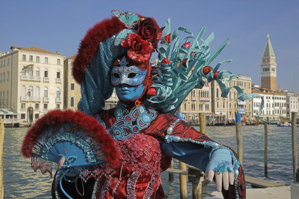 Female mask with colorful costume at carnival in Venice
