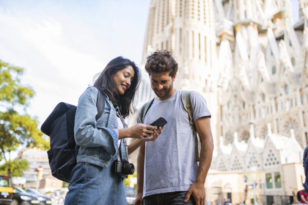 Young Tourist Couple Looking at Smart Phone in Barcelona