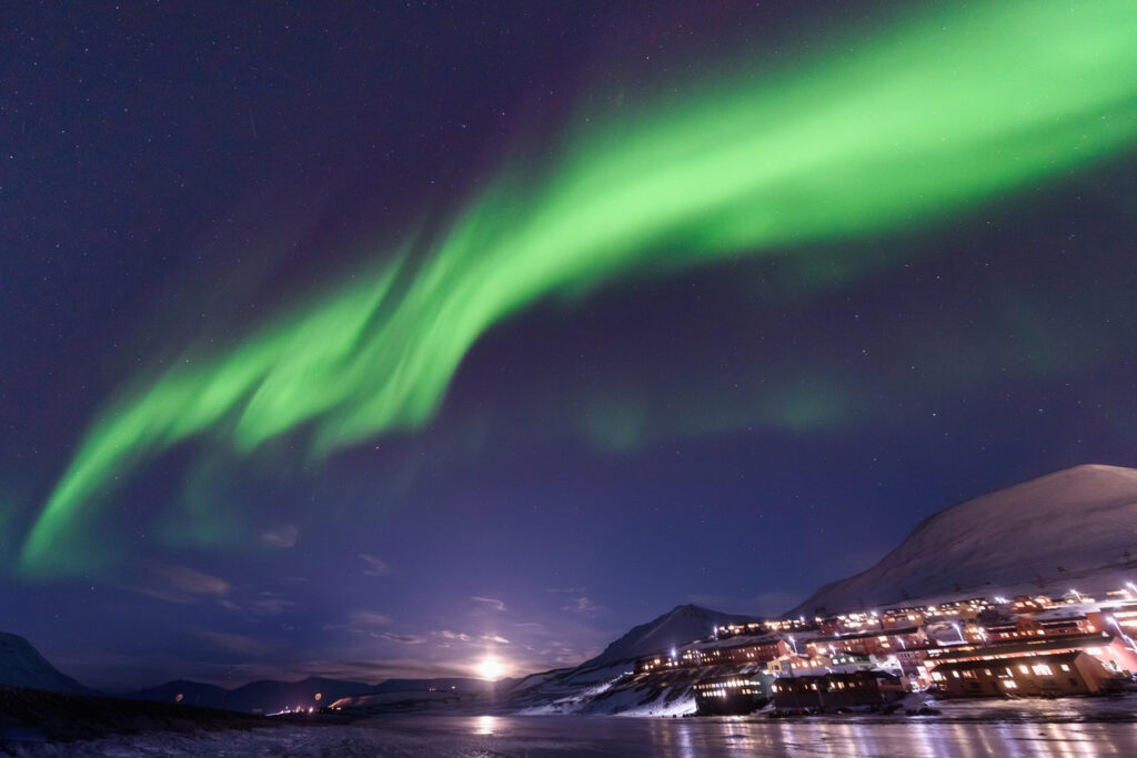 polar arctic Northern lights aurora borealis sky star in Norway Svalbard in Longyearbyen city mountains
