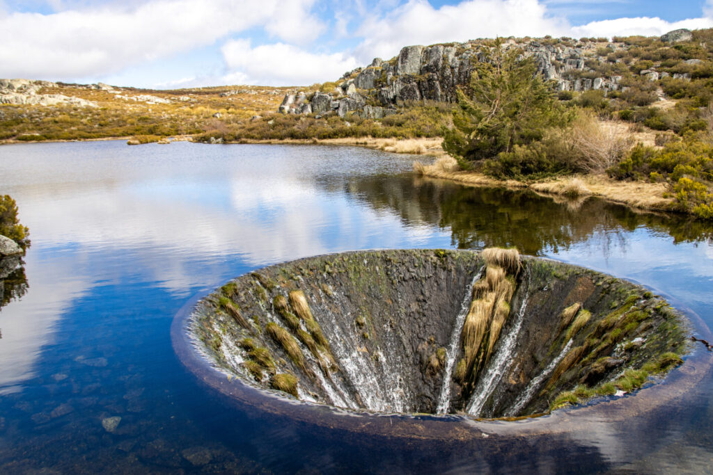 Covao Dos Conchos - A hole in the middle of the Lake in Serra da Estrela. Bell mouth spillway in Portugal