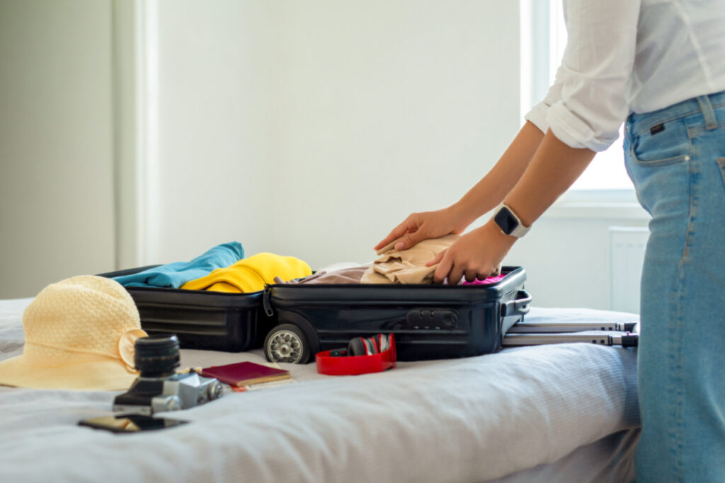 Woman preparing suitcase for holidays
