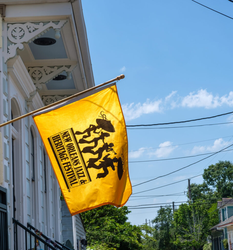 New Orleans Jazz and Heritage Festival Flag hanging from the front of a historic home in the Bywater Neighborhood on May 7, 2022 in New Orleans, LA, USA