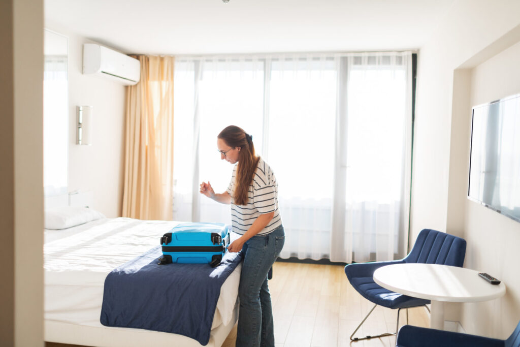 adult woman packing clothes suitcase