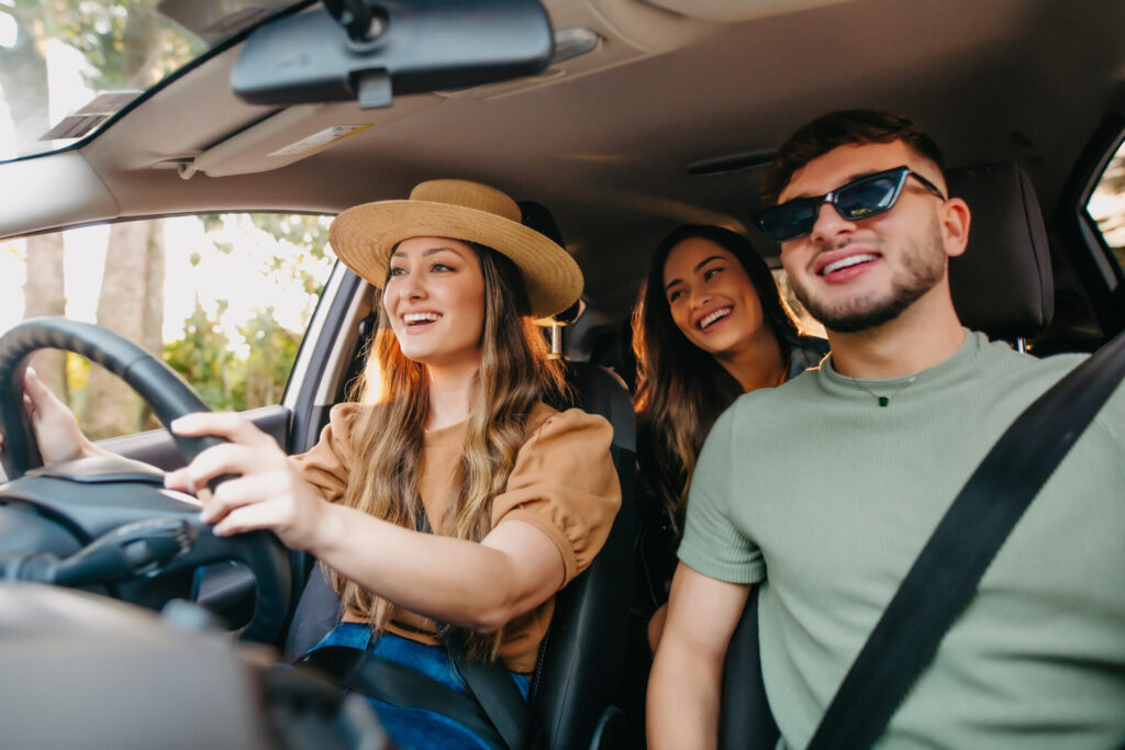 happy friends traveling by car