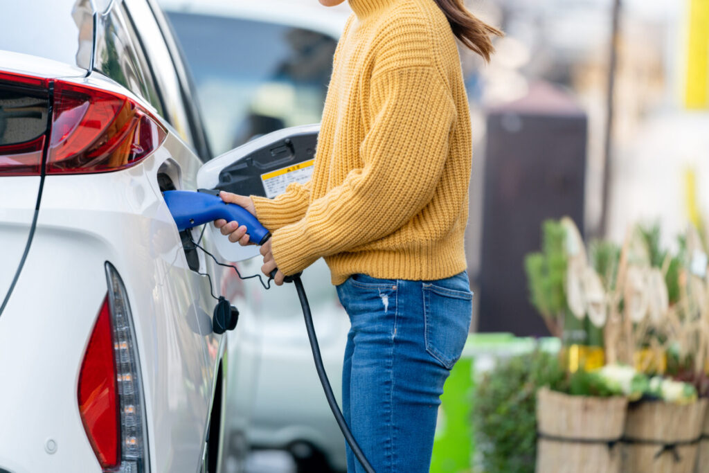 Close up plugging in electric car charger