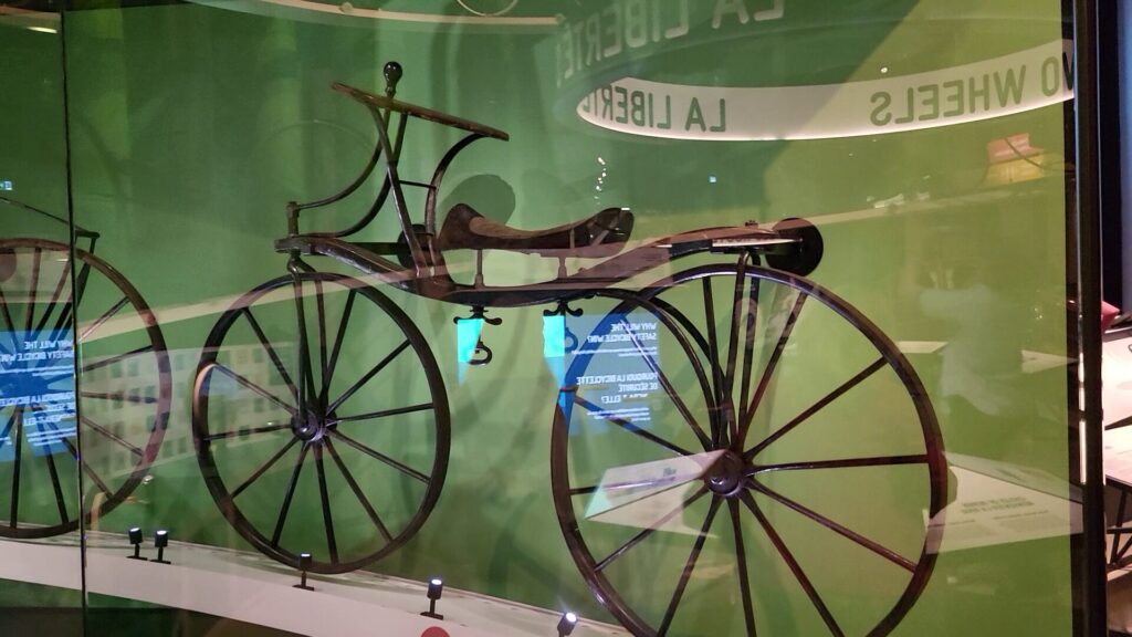 Image of the "Hobby horse" 18th century bicycle in a display case at a musueum