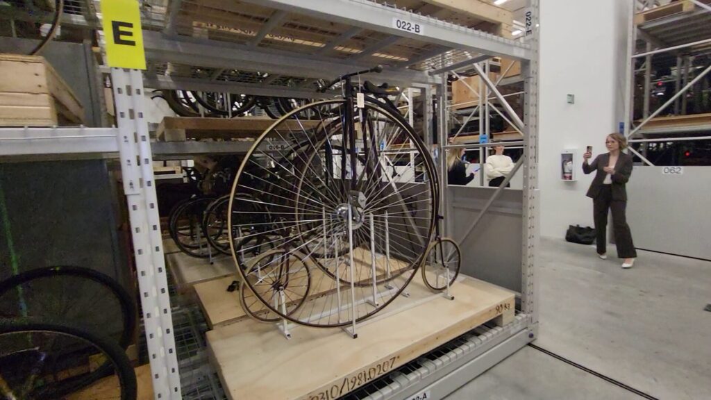 Image of an old Penny Farthing bike in museum storage