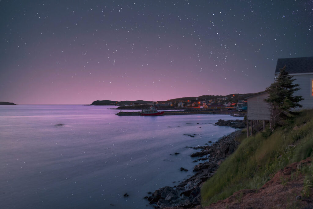 A starry night view looking out over Twillingate Harbour and out towards the North Atlantic Ocean in Newfoundland.